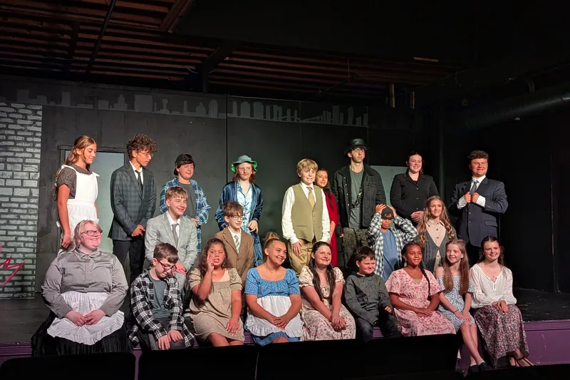 The full cast of Oliver! The Musical photographed on stage