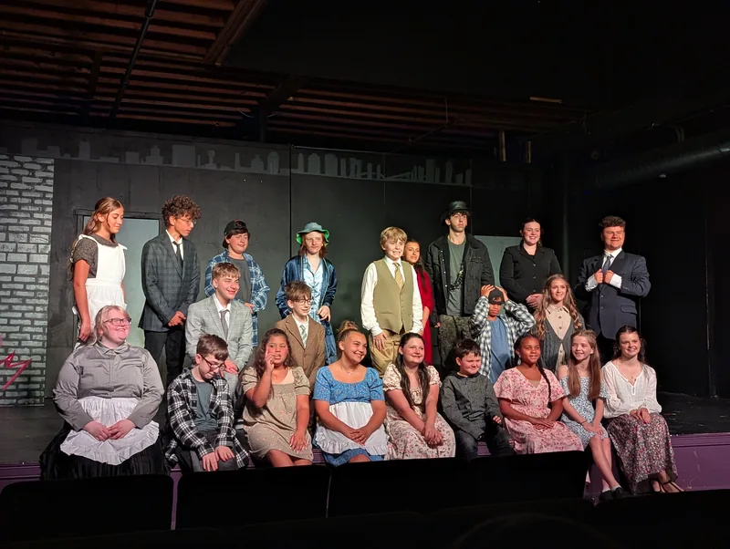 The full cast of Oliver! The Musical photographed on stage