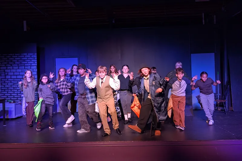 The company of Oliver! The Musical in a full stage number