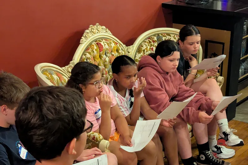 Students reading through their scripts together