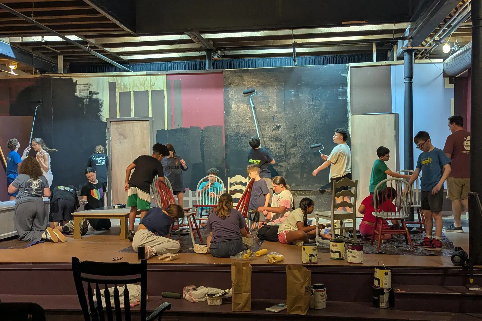 The company building and painting the set for Oliver! The Musical