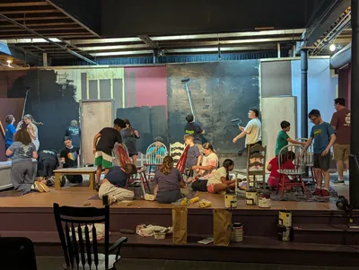 The company building and painting the set for Oliver! The Musical