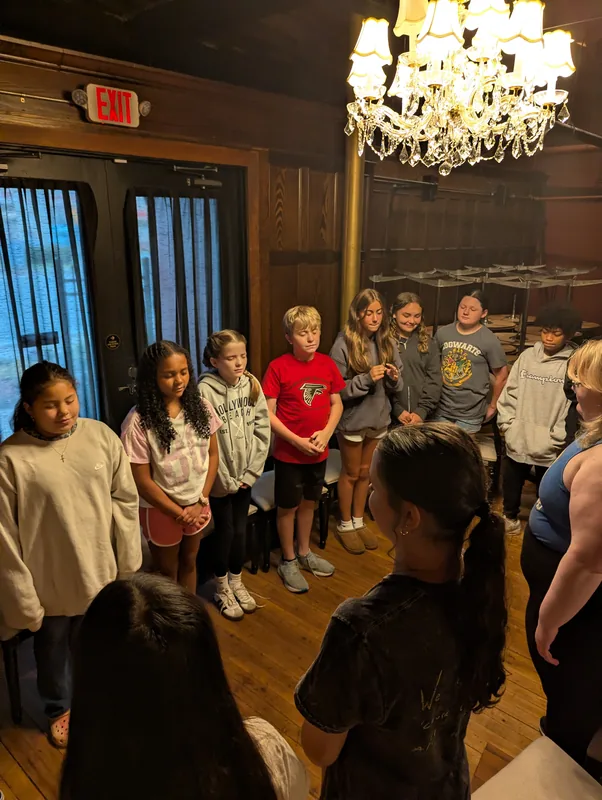 Students gathered in a circle during a workshop session